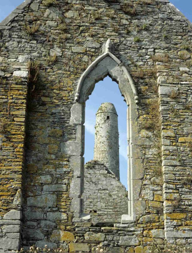 View of round tower through window ruin View of round tower through window ruin
