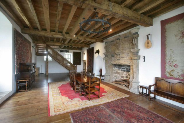 Donegal Castle interior with large ornate stone fireplace