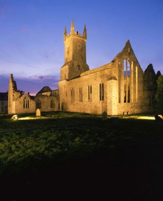 Night-time view of the back of the church at Ennis Friary