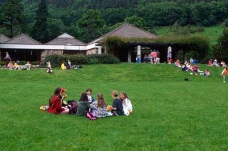 People picnicking on the grass in front of the Visitor Centre