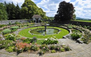 Overall view of the sunken garden where circular terraces descend down to the elliptical pool with the fountain