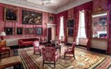 A glimpse of the Red Drawing Room after conservation of the silk wall hangings, showing the fabulous picture hang and the new curtains and upholstery made of silk reproduced to match the original (photo by David Davison)