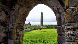View of round tower at Scattery Island through an arch.