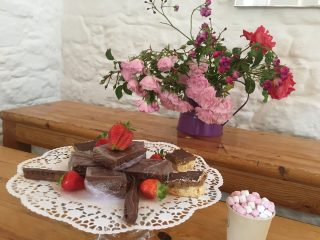 Cake slices and flowers in Charles Fort tearooms