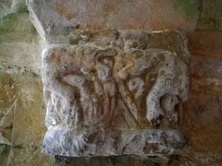Two fighting animals on a capital stone in the north doorway