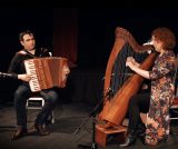 Martin Tourish playing the accordion alongside Tríona Marshall playing the harp