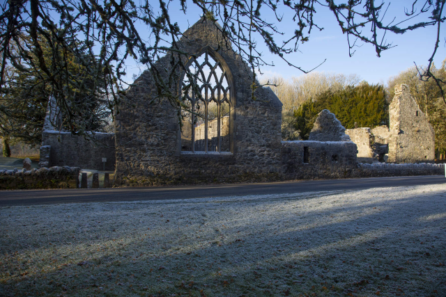 The wall remains of a church with the outlines of where the stained glass window used to be