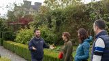 3 people get a guided tour of the gardens
