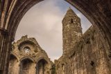 view from inside the ruins of the Rock of Cashel, looking up at the round tower