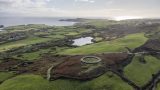 Aerial view of the fields at ocean surrounding Knockdrum stone fort