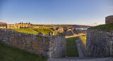 The Solider Quarters, the Hospital ward and the Lighthouse of Charles Fort. The sky is blue and the sea is visible in the bakground.