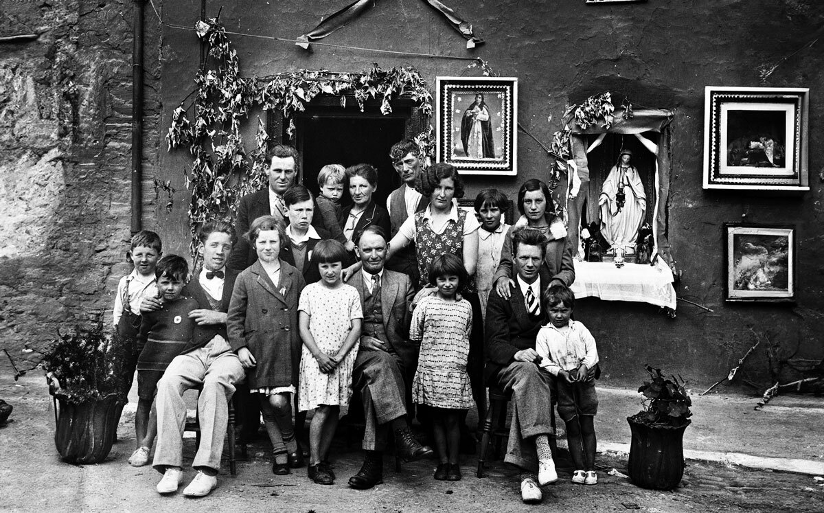 A black and white image of a large family. This is a promotional image for the Society and State exhibition, consisting of over one hundred records from the National Archive.