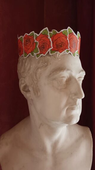 A handmade paper rose crown on a marble bust