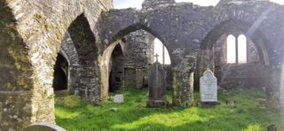 The internal ruins of the abbey with a view of some of the gravestones under the arches