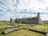 Full side view of Rathfran abbey with maze like stone-work surrounding it, marking the ruins left behind