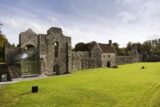 the ruins of boyle abbey with grass in front, and a renovated glass section to the left side of the abbey ruins