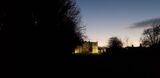 Rathfarnham Castle in the distance, spotlit and almost covered by a bush in the left foreground