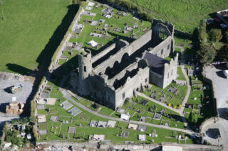 aerial view of the roofless church, the graveyard surrounding it in a circle