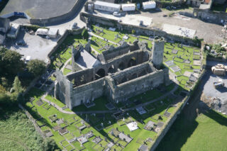 aerial view of the roofless church, the graveyard surrounding it in a circle