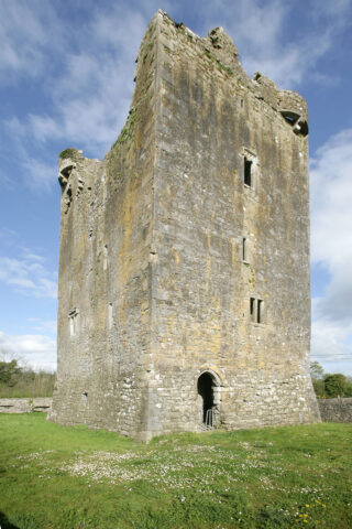 the castle reaches up towards the blue sky with its roofless structure