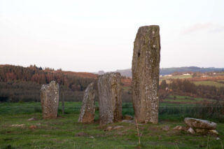 Close-up of the stone row, with the rugged landscape in the distance