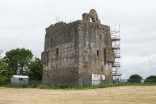 view of the stone, roofless castle, with scaffolding covering one side