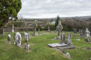 the high crosses within the surrounding cemetery of tombstones