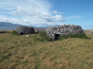 2 beehive-like huts sit side-by-side on the island