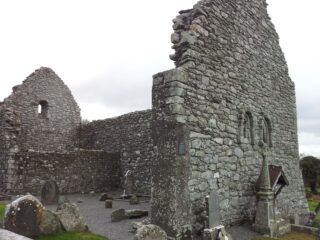 the stone remains of the church within a graveyard