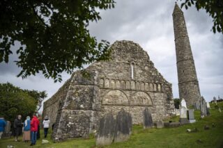 the front facade of the cathedral, with the round tower looming above just beside it.