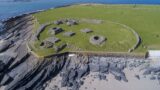 aerial view of an island with remains of a monastic site visible