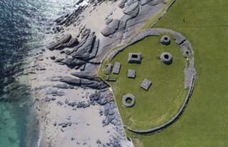 aerial view of the monastic site on the edge of the rocky beach of the island