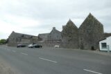 view of the intact abbey and infirmary building ruins from the road viewpoint