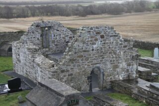 the roofless ruins of the church near the tower