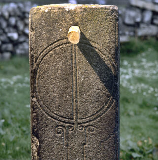 a stone sundial with a simple circular pattern carved into it