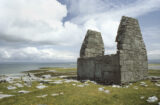 a small, roofless church overlooking the view of the Atlantic Ocean