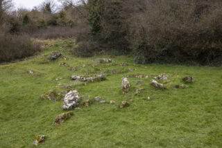 the stone remains strewn within the grass are the only things left from this national monument