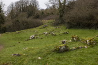 the stone remains strewn within the grass are the only things left from this national monument