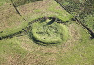 a closer view of the ringfort set within green fields