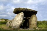 two standing stones, with a stone capped over them, creating a small dark passage in the centre