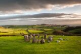 the sun setting on the stone circle