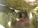 entrance under the stones. The stones are stacked in such a way that the back of the entrance is shaped like a square.