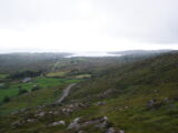 the surrounding rocky landscape of mount gabriel, with the sea in the far distance.