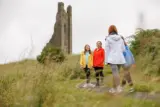 a family of 4 meet outside Trim Castle