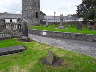 view of the bottom half of the tower within a grassy graveyard