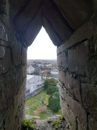 a view looking out over the town from the small entrance door of the tower