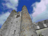 a stone round tower reaching towards the sky