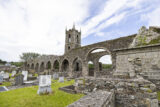 view of the monastery archways, tower, and graveyard.