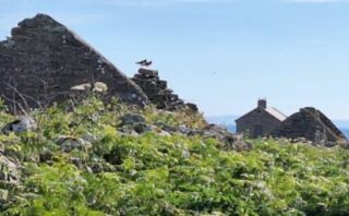 a view of the top of one of the churches on the island, that is now roofless.