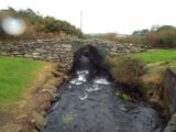 direct look at the bridge, with the river flowing under its small arch.
